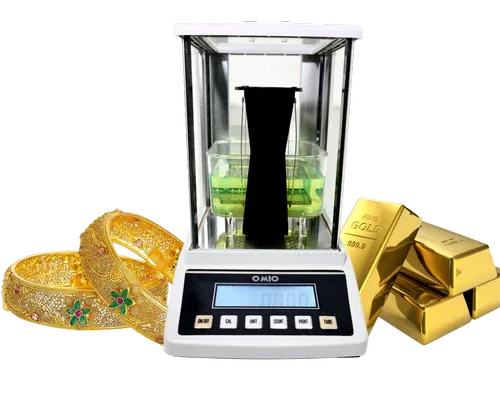 Omio Gold Testing Machine with gold jewellery and gold bars